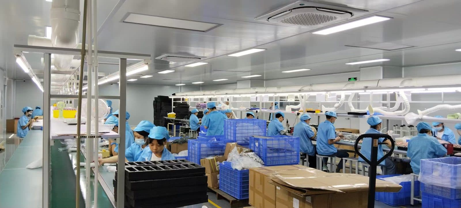 Wide view of SiLeap's baby nasal aspirator assembly and packing line with gowned staff