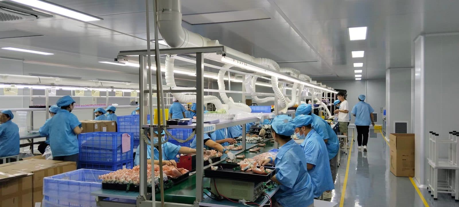 Gowned staff packing finished baby nasal aspirators at the end of SiLeap's production line
