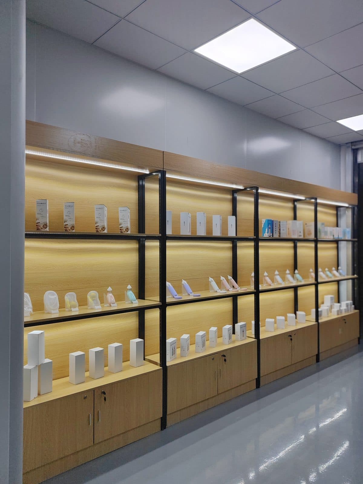 Backlit product showroom displaying SiLeap's baby nasal aspirator range